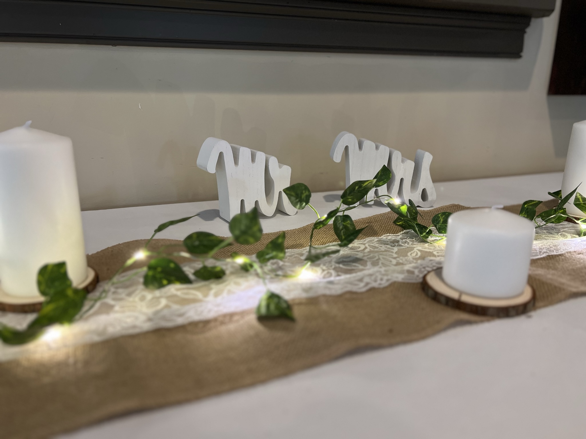 Wedding reception table decor with candles and greenery